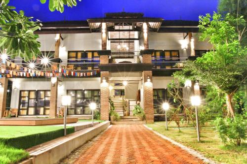 an exterior view of a house at night at Above The Sea Maesariang in Mae Sariang