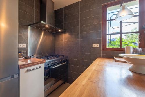a kitchen with a stove and a sink at Villa Delb in Arthez-dʼAsson