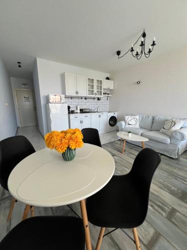 a kitchen and living room with a table and chairs at Studio E32 Atia Resort Chernomoretz in Chernomorets