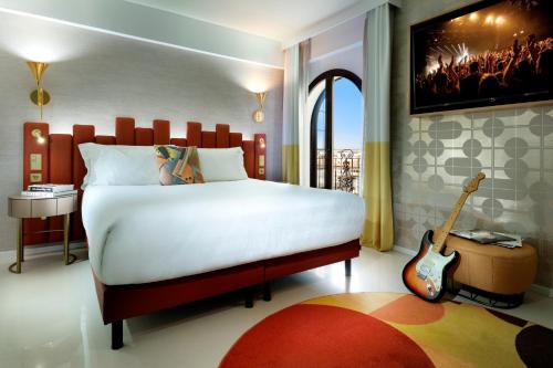 a bedroom with a bed with a guitar in it at Hard Rock Hotel Marbella - Puerto Banús in Marbella