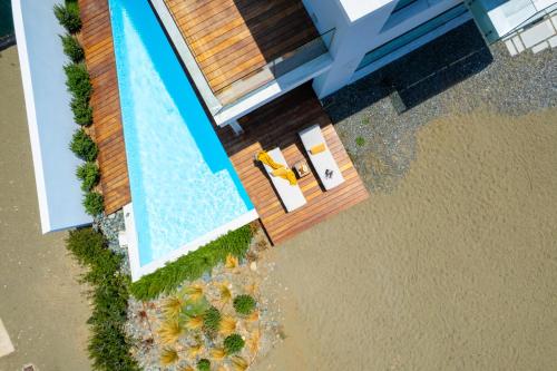 an overhead view of a house with a swimming pool at Blue Iris Luxury Beach Villa by Nomads - Steps to Beach in Kato Yialia