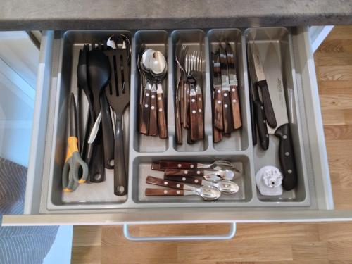 a drawer filled with utensils on top of a counter at Fortuuna 5 Apartment in Tartu