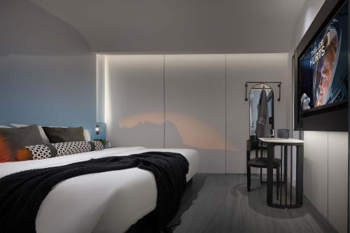 a bedroom with a large bed and a tv at Taikoo Li Premier Hotel Chengdu by Enji (Panda & Tianfu) in Chengdu