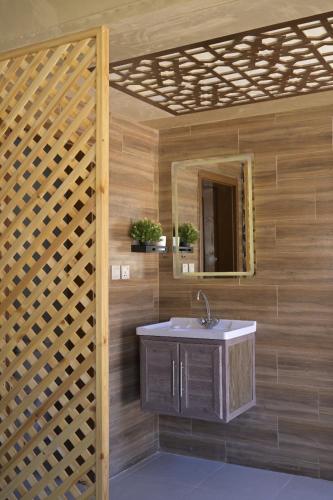 a bathroom with a sink and a mirror at Wadi Rum Desert Secret in Wadi Rum