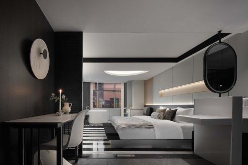 a bedroom with a white bed and a desk and a desk at Taikoo Li Premier Hotel Chengdu by Enji (Panda & Tianfu) in Chengdu