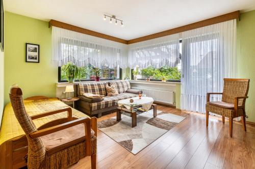a living room with a couch and a window at Ferienwohnung Neuenrade in Neuenrade