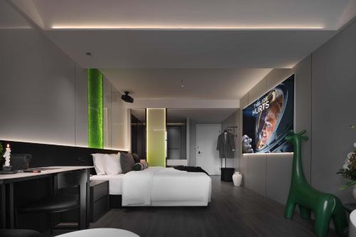a hotel room with a white bed and a desk at Taikoo Li Premier Hotel Chengdu by Enji (Panda & Tianfu) in Chengdu
