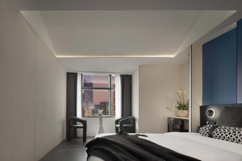 a bedroom with a bed and a window at Taikoo Li Premier Hotel Chengdu by Enji (Panda & Tianfu) in Chengdu