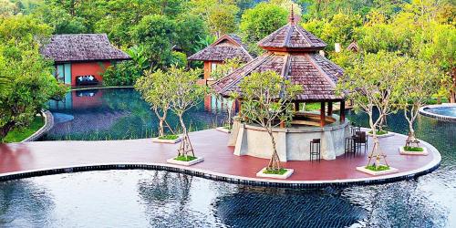 an island in the middle of the water with a house at Sibsan Resort & Spa Maetaeng Chiang Mai in Mae Taeng