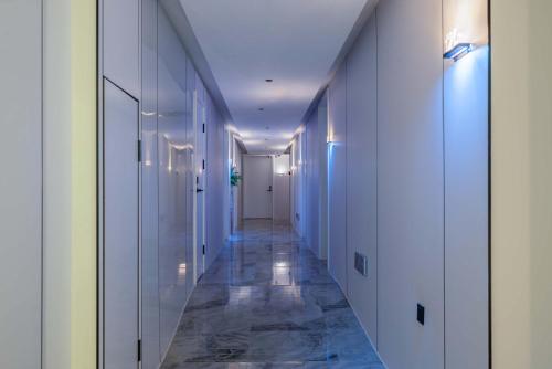 a long hallway with white walls and marble floors at Taikoo Li Premier Hotel Chengdu by Enji (Panda & Tianfu) in Chengdu