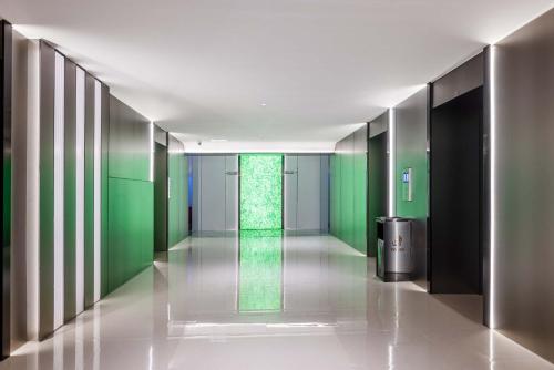 a hallway with green walls and a green wall at Taikoo Li Premier Hotel Chengdu by Enji (Panda & Tianfu) in Chengdu