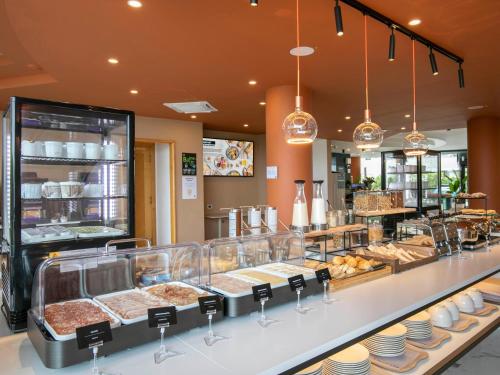 a bakery counter with many different types of food at B&B HOTEL Latina in Latina