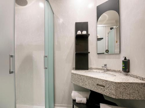 a bathroom with a sink and a shower at B&B HOTEL Latina in Latina