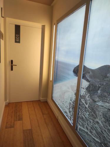 a room with a door with a view of the ocean at Hotel Carboneras Cabo de Gata Spa in Carboneras