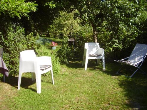 a group of chairs sitting in the grass at Gîte paisible avec jardin privé, cheminée et équipements modernes au cœur du Parc Naturel de l'Avesnois - FR-1-510-98 in Choisies