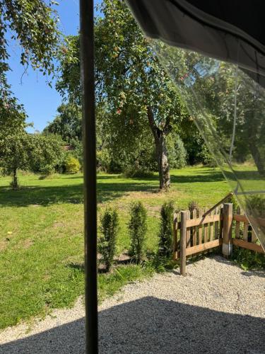 a tent with a fence in a park at Camping Relaxing im Garten in Wettringen