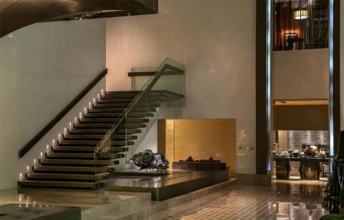 a spiral staircase in a building with a lobby at Park Hyatt Abu Dhabi Hotel and Villas in Abu Dhabi
