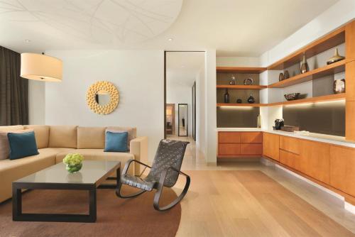 a living room with a couch and a table at Park Hyatt Abu Dhabi Hotel and Villas in Abu Dhabi
