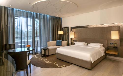 a bedroom with a bed and a desk and a chair at Park Hyatt Abu Dhabi Hotel and Villas in Abu Dhabi