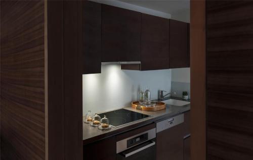 a kitchen with brown cabinets and a sink at Park Hyatt Abu Dhabi Hotel and Villas in Abu Dhabi