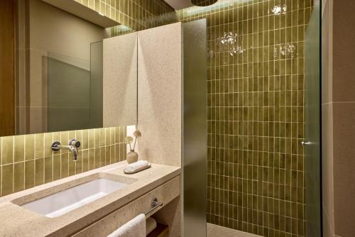a bathroom with a sink and a mirror at Avali, Mar-Bella Collection in Agios Ioannis Peristeron