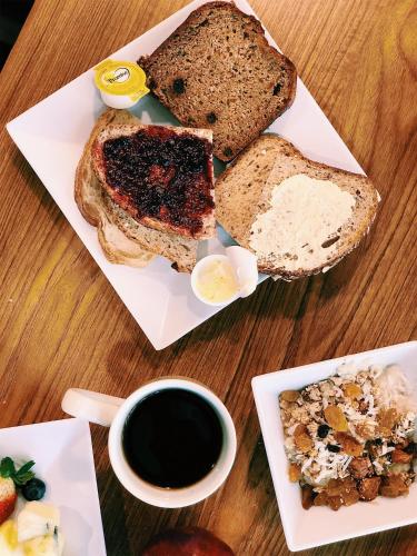 a table with a plate of bread and a cup of coffee at Hyatt Place Memphis Germantown in Memphis