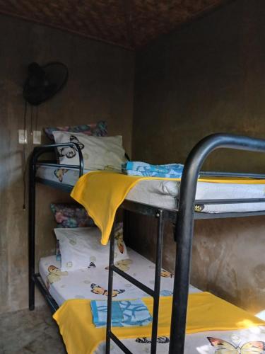 a group of bunk beds in a room at DUMA Hostel in Bantinguil