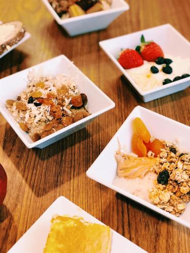 a wooden table with plates of different types of food at Hyatt Place Memphis Germantown in Memphis