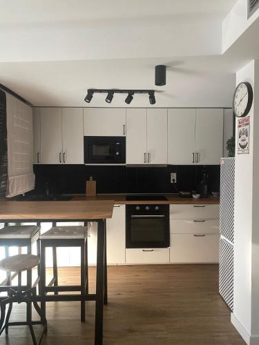 a kitchen with a table and chairs and a clock at Casa Pilar in Sos del Rey Católico
