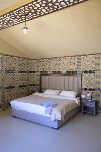 a bedroom with a large bed in a room at Wadi Rum Desert Secret in Wadi Rum