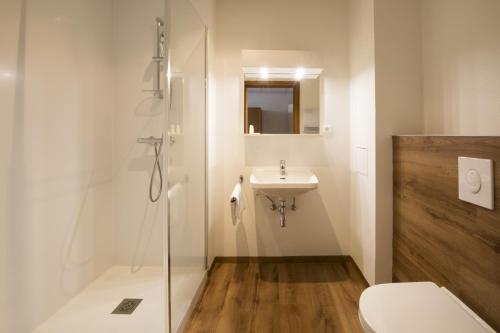 a bathroom with a toilet and a sink at Hôtellerie du Couvent Oberbronn in Oberbronn