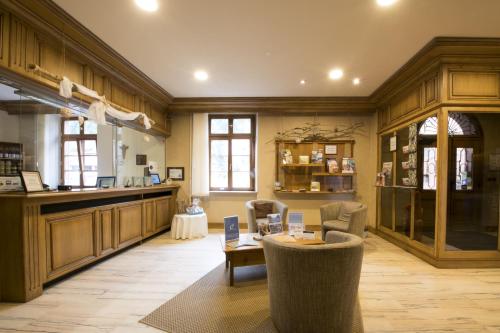 a large room with a table and chairs in it at Hôtellerie du Couvent Oberbronn in Oberbronn