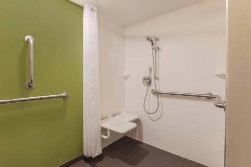 a bathroom with a toilet and a shower at Sleep Inn Midway Airport in Chicago
