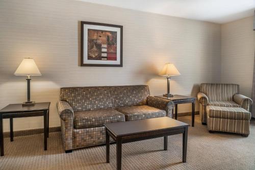a living room with a couch and a chair at Quality Inn & Suites Next to the Casino in Ceresco