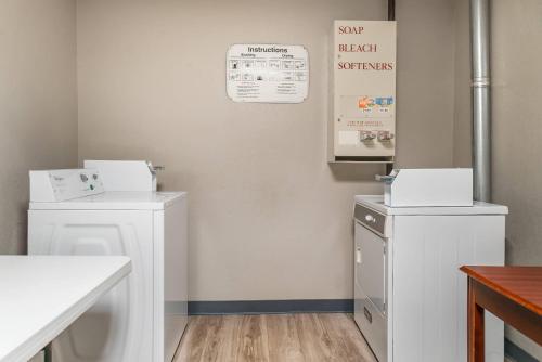 a bathroom with two washing machines and a sink at Quality Inn & Suites Next to the Casino in Ceresco