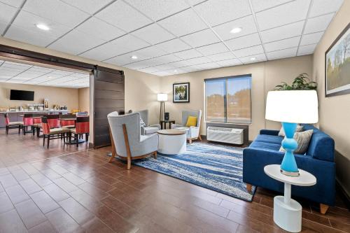 a living room with a blue couch and chairs at Comfort Inn & Suites Oxford South in Oxford