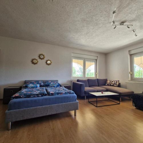 a bedroom with a bed and a couch at Family Apartment Miki in Teslic in Teslić