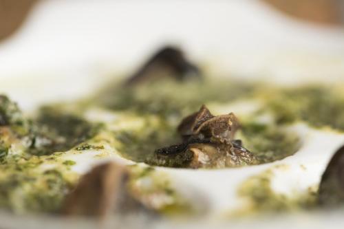 a close up of a dish of food with broccoli at Hôtellerie du Couvent Oberbronn in Oberbronn