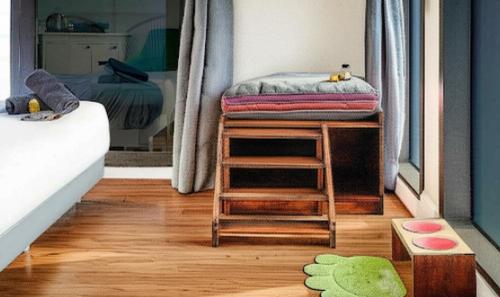 a bedroom with a bed and a mirror on a wooden floor at Gyeongju Mauna Ocean Resort in Gyeongju