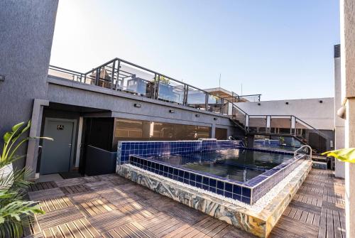 a hot tub on the deck of a building at Ramada Suites by Wyndham Asuncion Aeropuerto in Asuncion