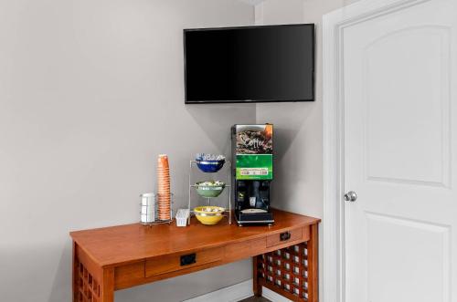 a table with a coffee maker and a television on a wall at Quality Inn Lexington in Lexington