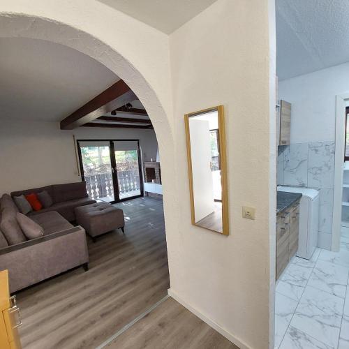 a living room with a couch and a mirror at Cozy apartment near the Rhine in Albbruck
