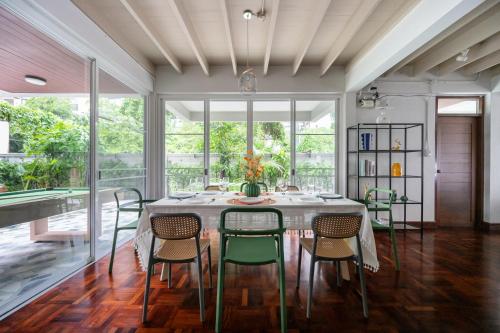 a dining room with a table and chairs at MIQ S22 Pool Villa PhromPhong Emsphere 5BR in Bangkok