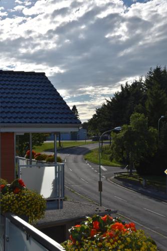 a view of a street with a building and flowers at Hotel Haus Seeblick in Nideggen