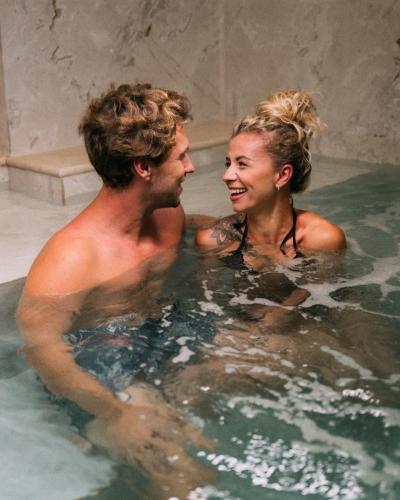 a man and a woman in a bath tub at Regional Hotel by NEU Collective in Il-Gżira