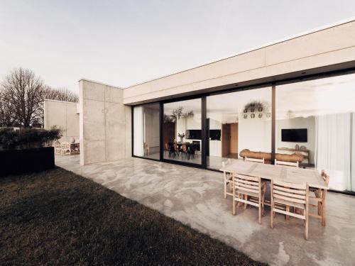 a house with a table and chairs on a patio at Cozy Villa in Dalhem Ardennes with Private Garden in Dalhem
