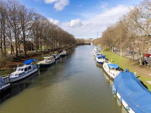 a group of boats docked on a river at Cozy Villa in Dalhem Ardennes with Private Garden in Dalhem