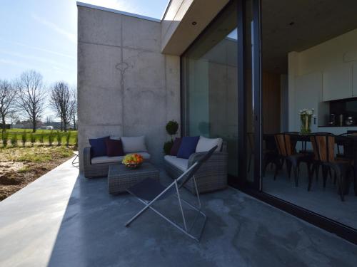 a patio with a couch and chairs and a table at Cozy Villa in Dalhem Ardennes with Private Garden in Dalhem