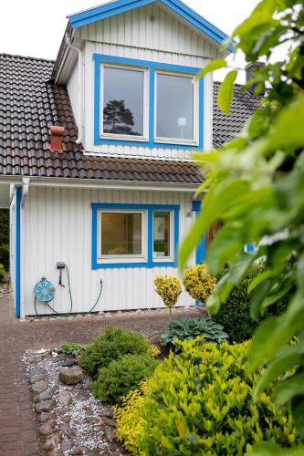 a house with a hose on the side of it at Apartment Near Sea and Nature, Free Parking & Cleaning in Gothenburg