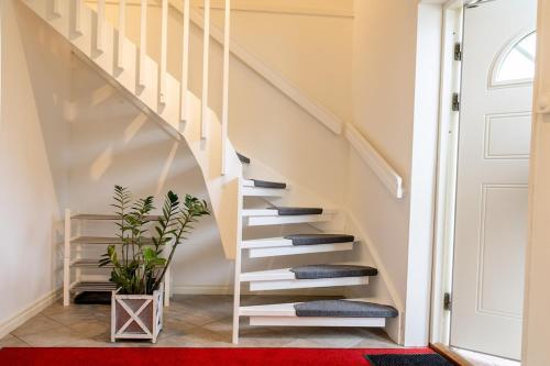 a staircase in a house with a red rug at Apartment Near Sea and Nature, Free Parking & Cleaning in Gothenburg